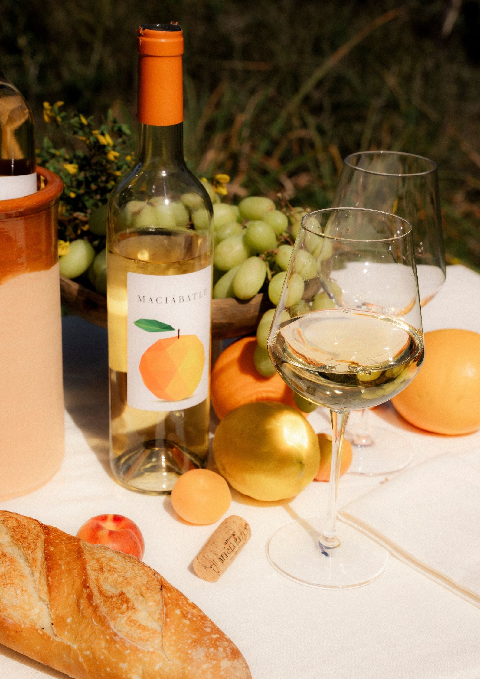 table setting outside with orange wine